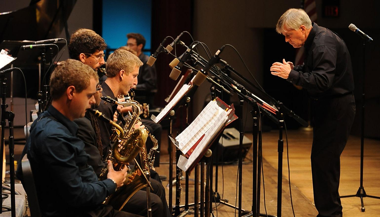 Student jazz band preparing to play wiht conductor